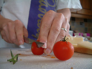 hands cutting tomato